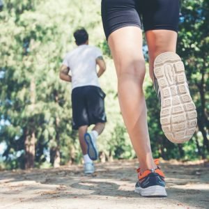 Young couple running in the park.